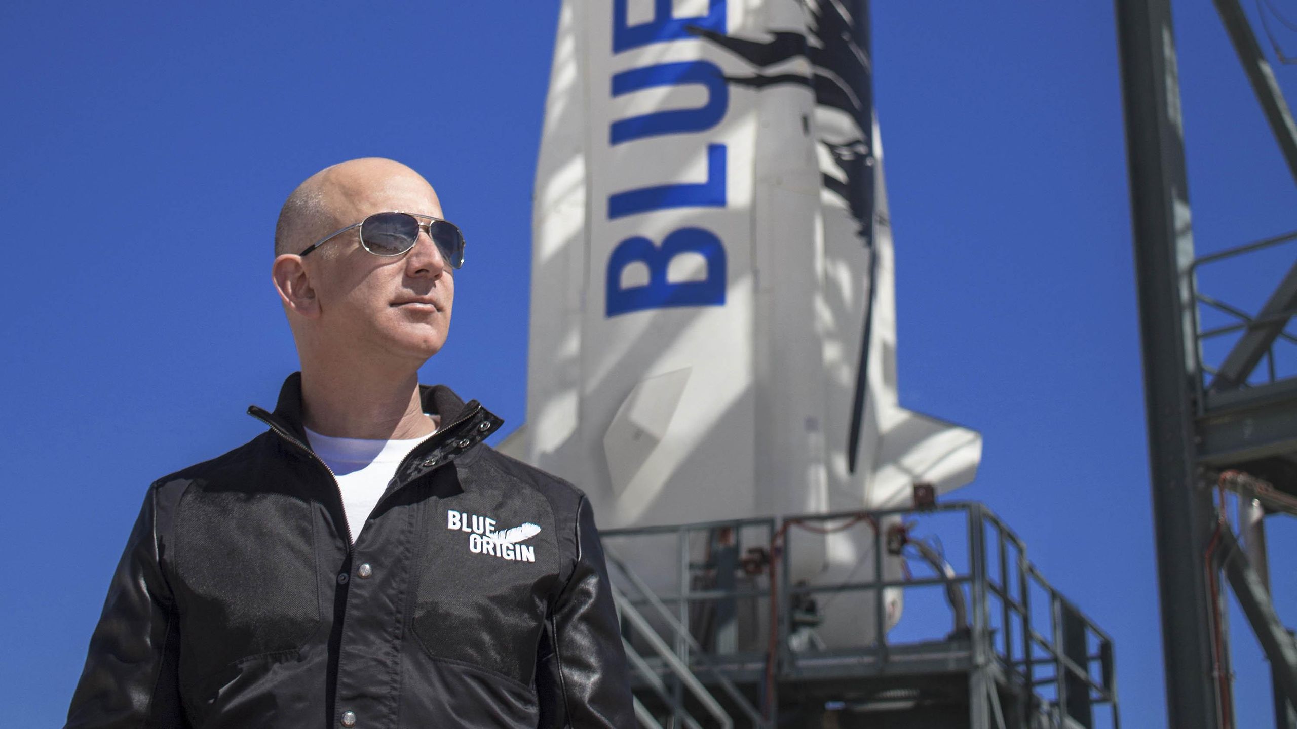 Jeff Bezos standing in front of Blue Origin Rocket