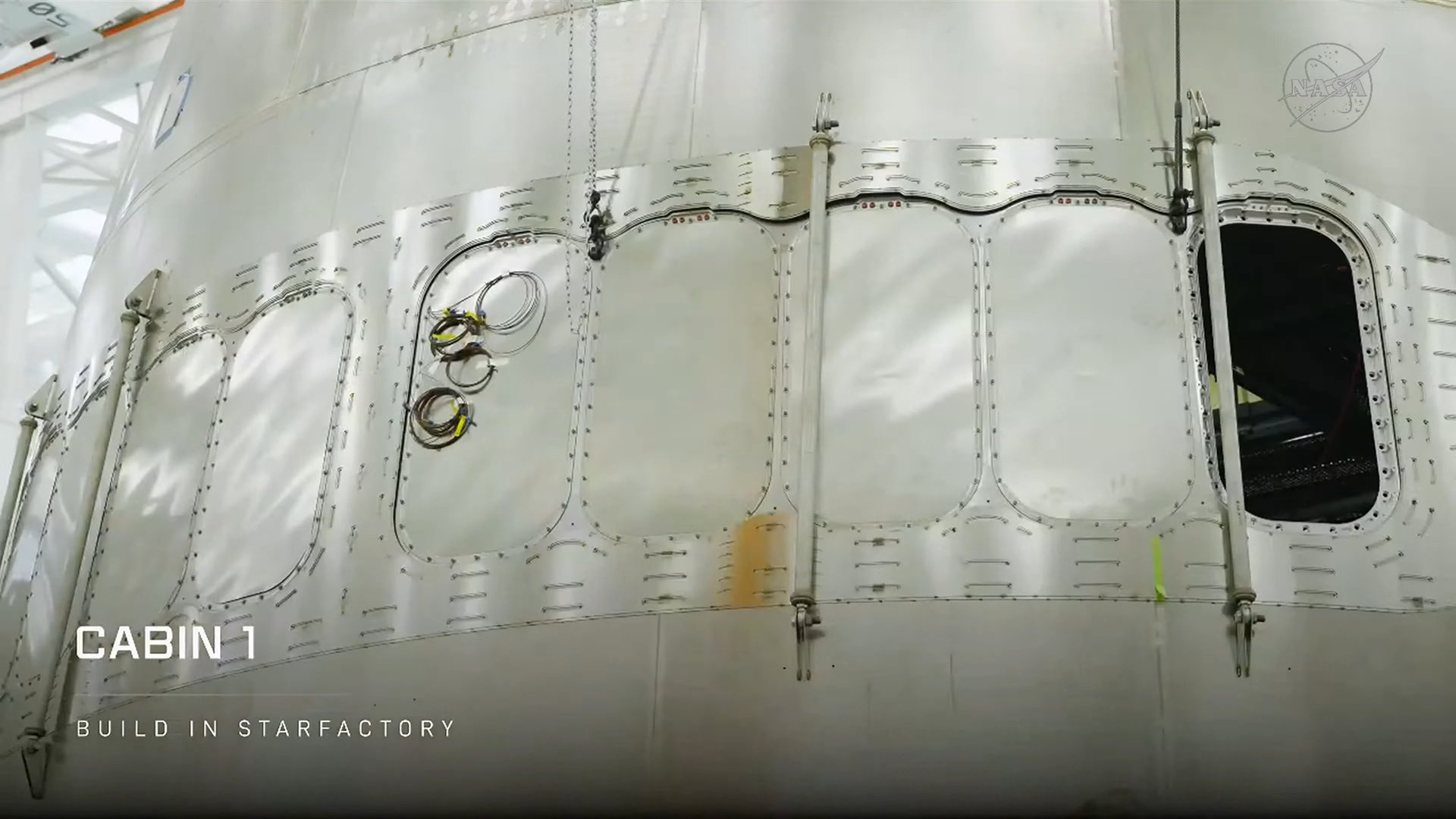 Window openings cut into the Starship hull for Cabin 1 at SpaceX's Starfactory